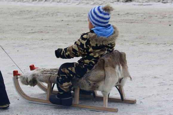 Camouflage 'onesie' and sled with seal-skin rug.....the  'must-haves' for kids in Greenland !