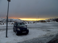 Late afternoon and a  snowy airport carpark.