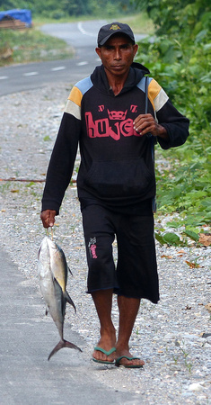 Fisherman with his catch at Bara, Buru.
